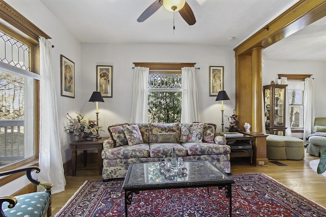 living room with wood finished floors and a ceiling fan