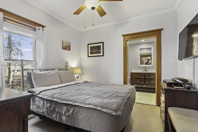 bedroom with ornamental molding, ceiling fan, light colored carpet, and ensuite bathroom