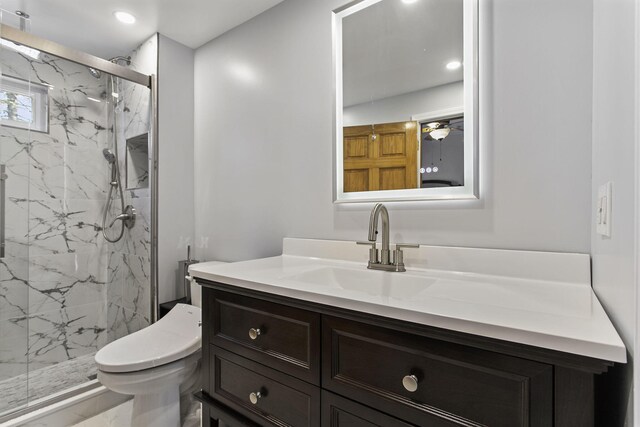 bathroom with recessed lighting, a marble finish shower, toilet, and vanity