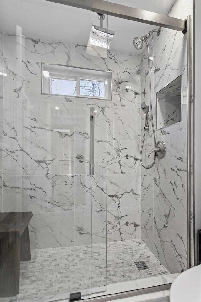 full bath with a marble finish shower
