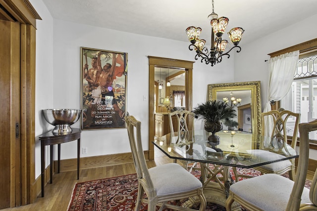 dining space featuring a chandelier and wood finished floors