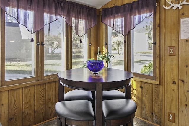 dining space with wood walls