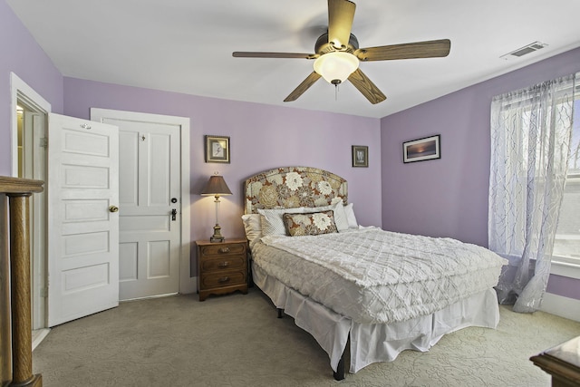 carpeted bedroom with visible vents and ceiling fan