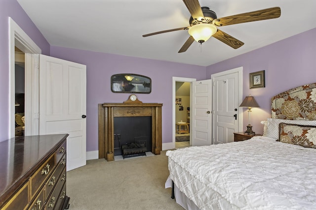 bedroom with ceiling fan, light carpet, and baseboards