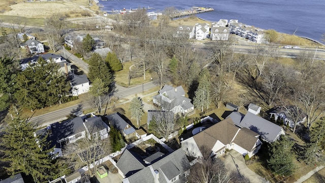 drone / aerial view with a water view and a residential view