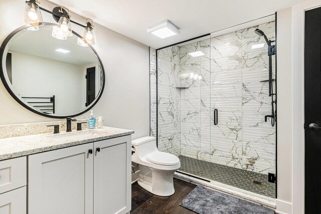 7505 S Lakeshore Dr, Pentwater, MI 49449 - bathroom with vanity, a chandelier, toilet, a shower stall, and wood finished floors