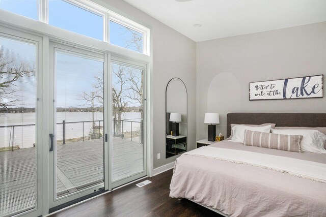 7505 S Lakeshore Dr, Pentwater, MI 49449 - bedroom featuring visible vents, access to exterior, baseboards, and dark wood finished floors