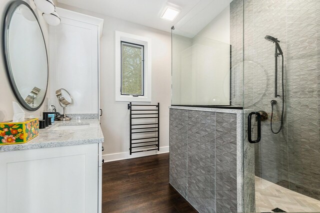 7505 S Lakeshore Dr, Pentwater, MI 49449 - bathroom featuring a shower stall, vanity, baseboards, and wood finished floors
