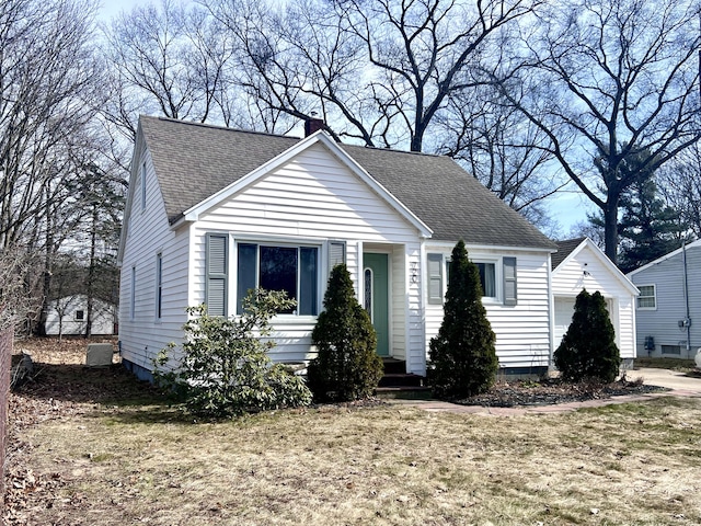 bungalow featuring cooling unit, roof with shingles, an outdoor structure, and a chimney