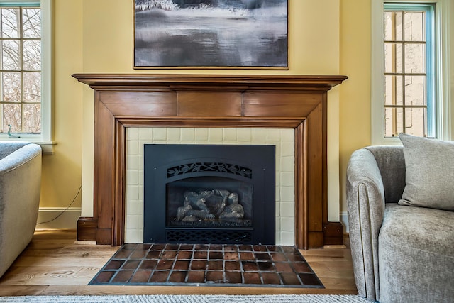 interior details with baseboards, a fireplace, and wood finished floors
