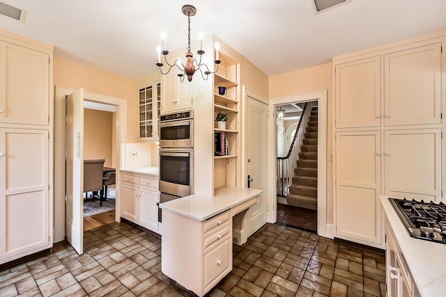 kitchen featuring open shelves, double oven, light countertops, brick patterned floor, and black gas cooktop