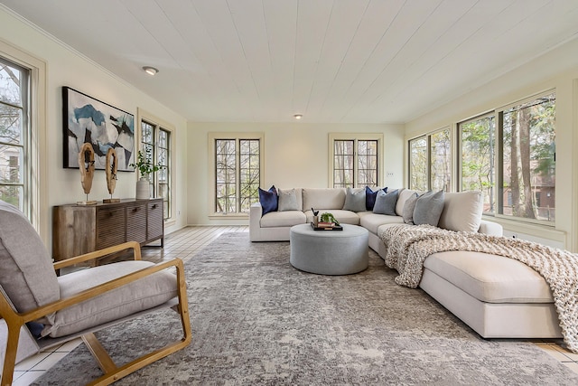 living area featuring crown molding and wood ceiling