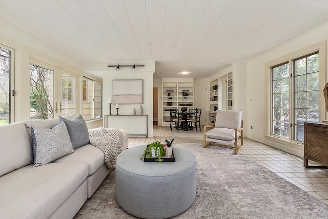 living room with track lighting, tile patterned floors, built in shelves, and wood ceiling