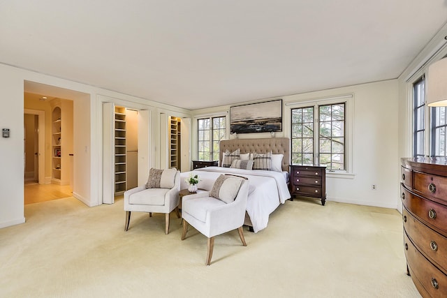 bedroom with baseboards, light carpet, and multiple windows