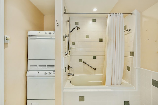 full bathroom with stacked washer and dryer and shower / tub combo