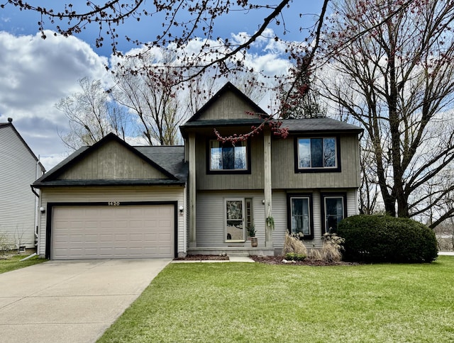 view of front of home with a garage, concrete driveway, and a front lawn