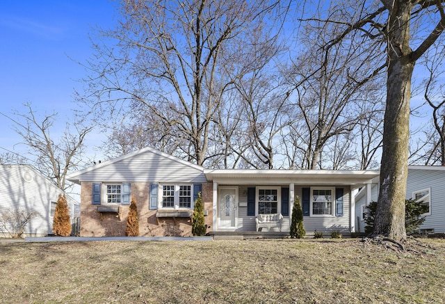 ranch-style home with covered porch and brick siding