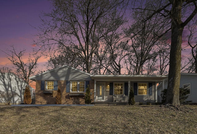 ranch-style home with brick siding and covered porch