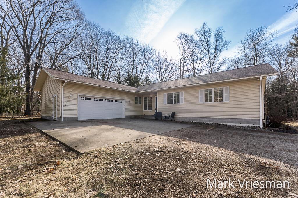 ranch-style home featuring an attached garage and concrete driveway