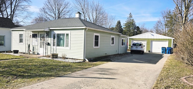 view of front of property with a front lawn, a detached garage, roof with shingles, an outdoor structure, and a chimney