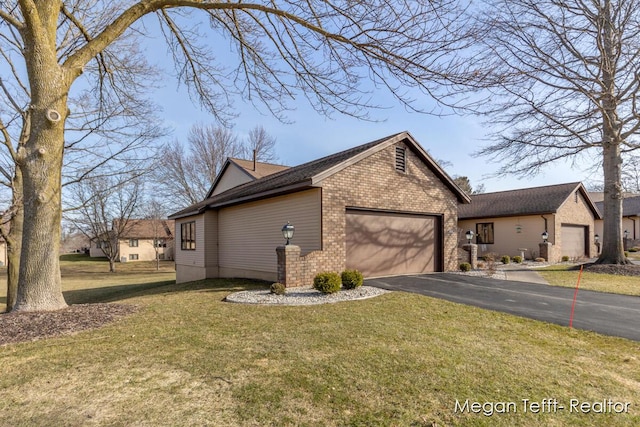 view of property exterior featuring aphalt driveway, an attached garage, a lawn, and brick siding