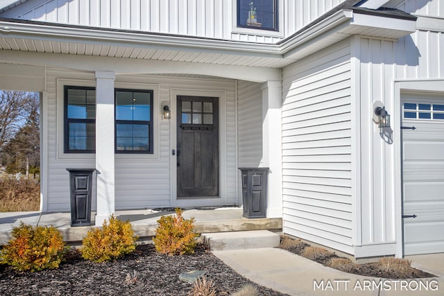 entrance to property with covered porch and board and batten siding