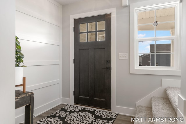 foyer with stairway, baseboards, and dark wood-style floors