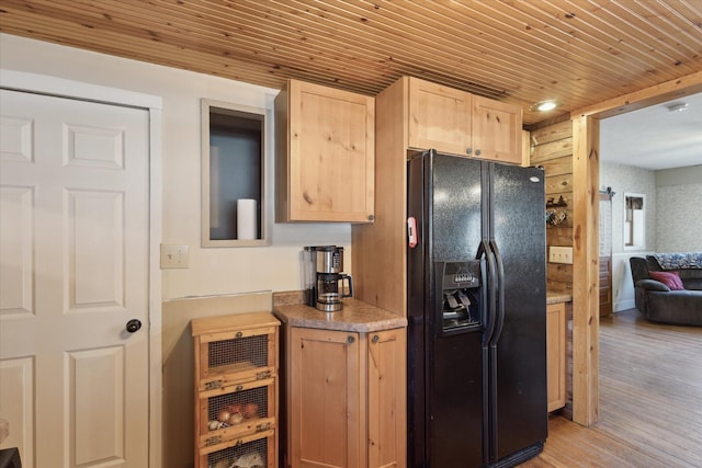 kitchen with light brown cabinetry, black fridge with ice dispenser, wood ceiling, and light wood-type flooring