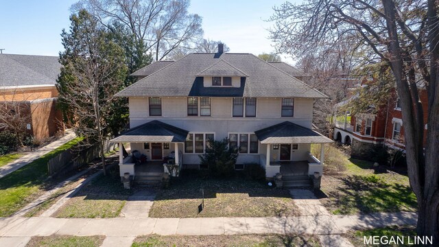 186 W 12th St, Holland, MI 49423 - american foursquare style home featuring a shingled roof and covered porch