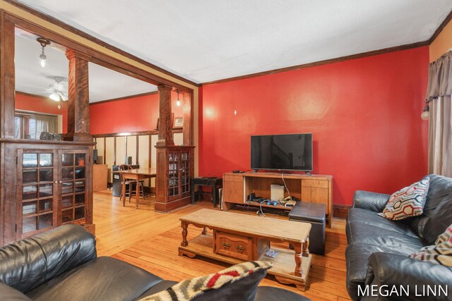 186 W 12th St, Holland, MI 49423 - living area featuring crown molding, a ceiling fan, hardwood / wood-style floors, and ornate columns