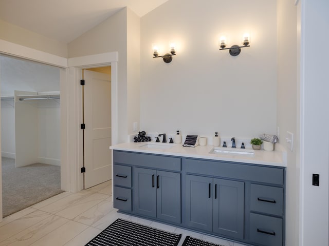 2613 Ashford Trl, Portage, MI 49024 - bathroom featuring lofted ceiling, a sink, a spacious closet, and marble finish floor