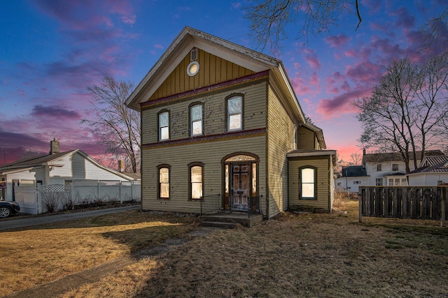 view of front of house with board and batten siding and fence