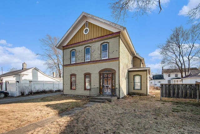 view of front of property with fence and board and batten siding