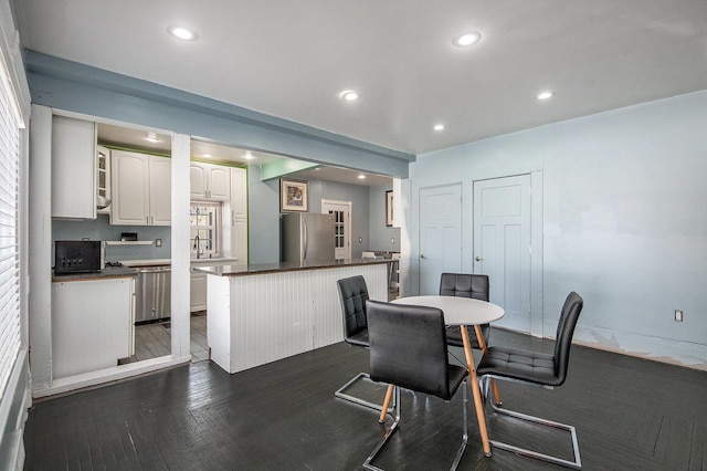 dining room featuring dark wood-type flooring and recessed lighting