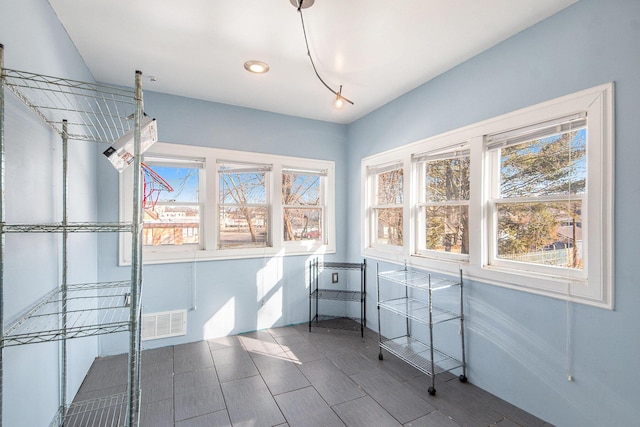 unfurnished sunroom with visible vents