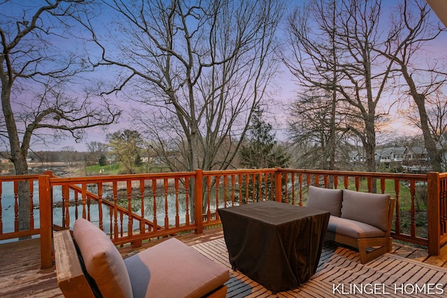 wooden terrace with an outdoor hangout area