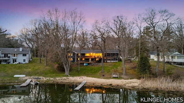 back of property with a yard and a deck