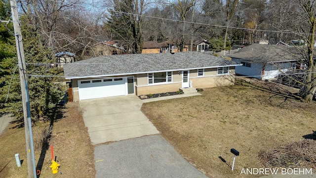 ranch-style house featuring a front lawn, an attached garage, driveway, and a shingled roof