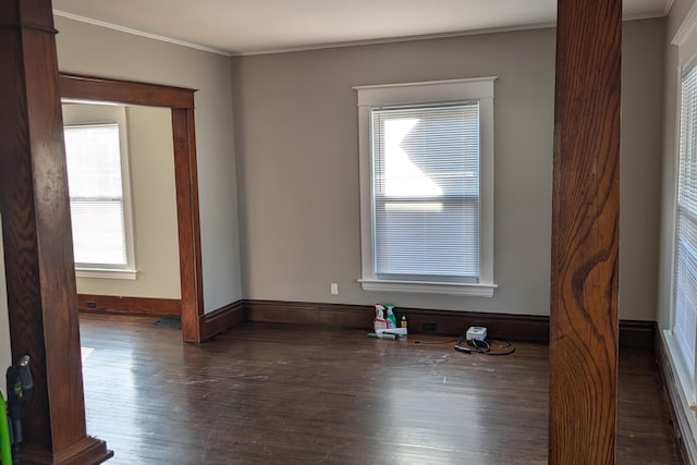 unfurnished room with baseboards, wood finished floors, and ornamental molding