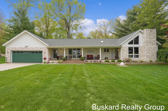 1127 Wolf Lake Dr, Baldwin, MI 49304 - view of front of property with stone siding, an attached garage, a front yard, and a porch