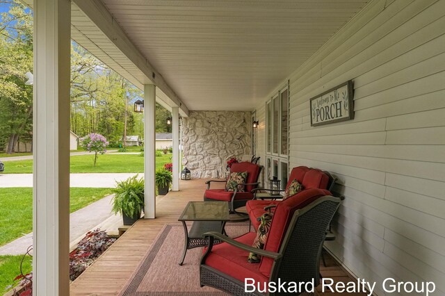 1127 Wolf Lake Dr, Baldwin, MI 49304 - covered porch featuring a lawn