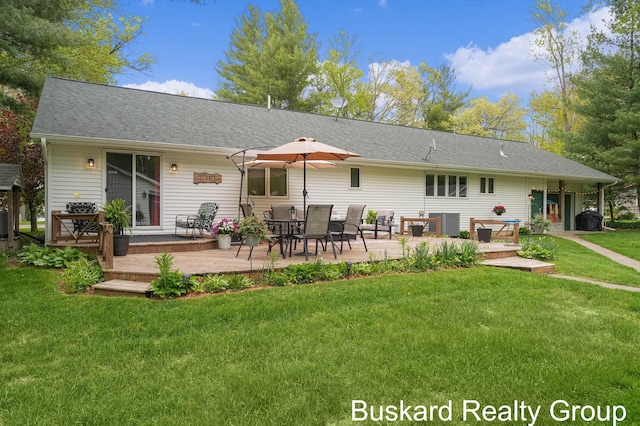 1127 Wolf Lake Dr, Baldwin, MI 49304 - back of property with a wooden deck, a lawn, a shingled roof, and central air condition unit