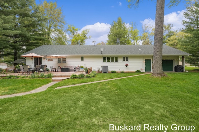 1127 Wolf Lake Dr, Baldwin, MI 49304 - rear view of property with an attached garage, a lawn, central AC unit, and a wooden deck