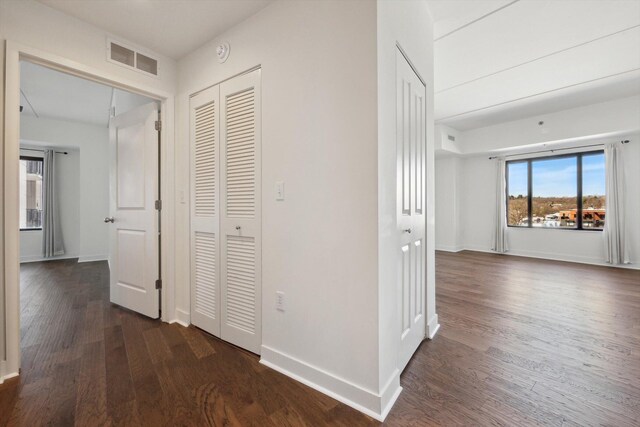 111 N Ashley St Unit 510, Ann Arbor, MI 48104 - hallway featuring visible vents, baseboards, and dark wood finished floors