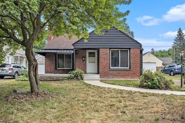 bungalow-style house featuring a front yard, brick siding, and a chimney