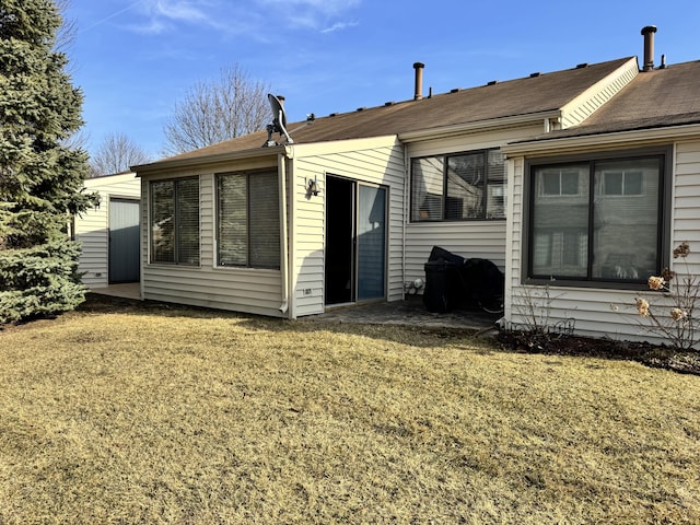 rear view of property with a yard