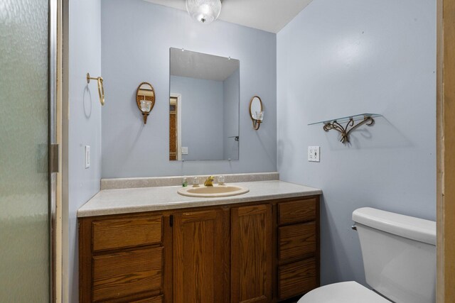 bathroom featuring toilet and vanity