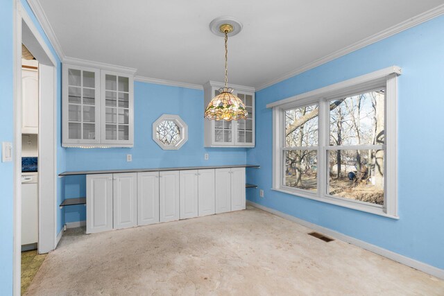 unfurnished dining area with visible vents, baseboards, and ornamental molding
