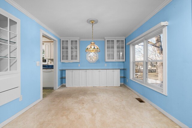 unfurnished dining area featuring visible vents, baseboards, crown molding, and an inviting chandelier