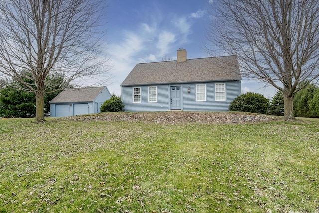 view of front of house with roof with shingles, a chimney, a front lawn, an outdoor structure, and a detached garage